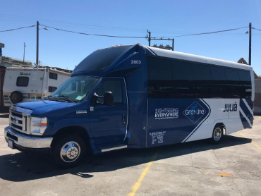 28 passenger bus that is dark blue with the Gray Line logo on the side that is ready for a Sonoma Valley tour