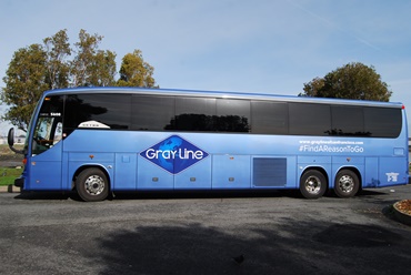 large 56 passenger bus that is blue with the Gray Line logo on the side that is ready for a SF Tour