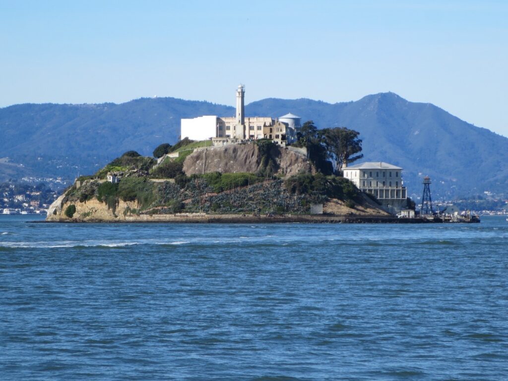alcatraz island with a blue bay and blue sky