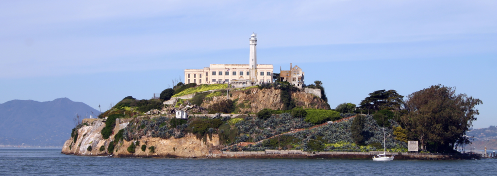 alcatraz prison on the island in a far view with the mountains in the background