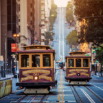 two cable cars in san francisco riding up the tracks