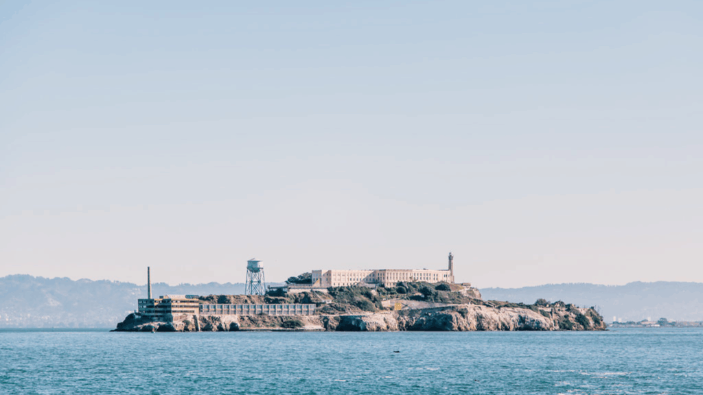 alcatraz prison on the island in a far view with the mountains in the background