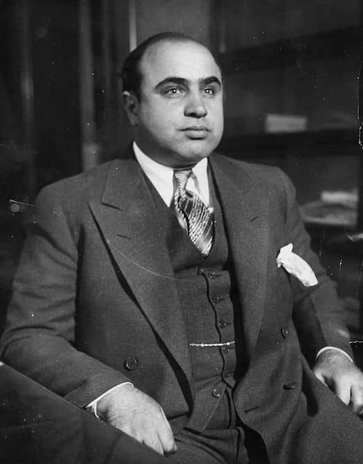 Al Capone sitting down, dressed in a suit, black and white